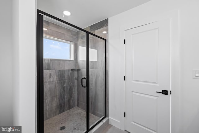 bathroom featuring a shower with door