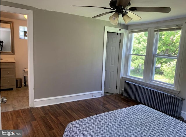 bedroom featuring radiator, ceiling fan, and hardwood / wood-style flooring