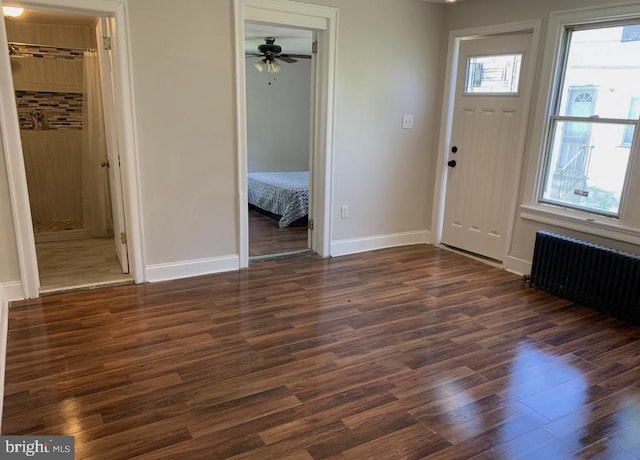 entrance foyer with radiator, dark hardwood / wood-style flooring, and ceiling fan