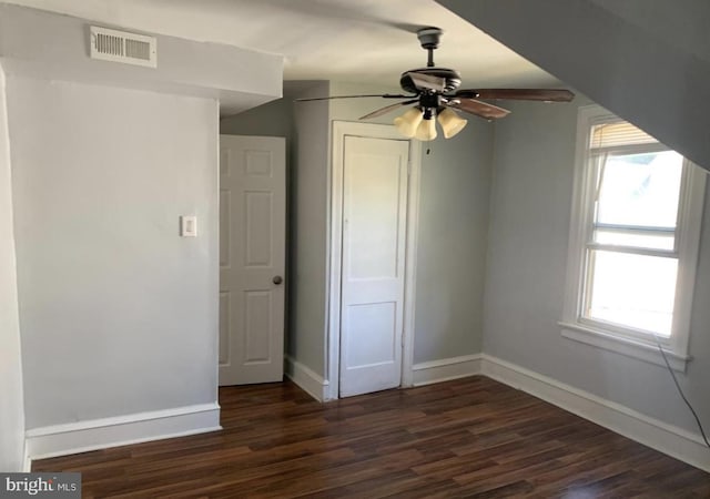 unfurnished bedroom with ceiling fan and dark hardwood / wood-style flooring