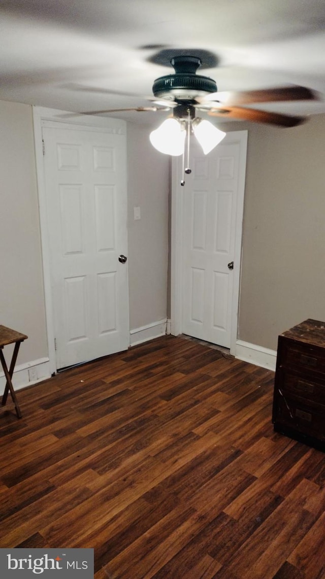 bedroom with ceiling fan and dark wood-type flooring