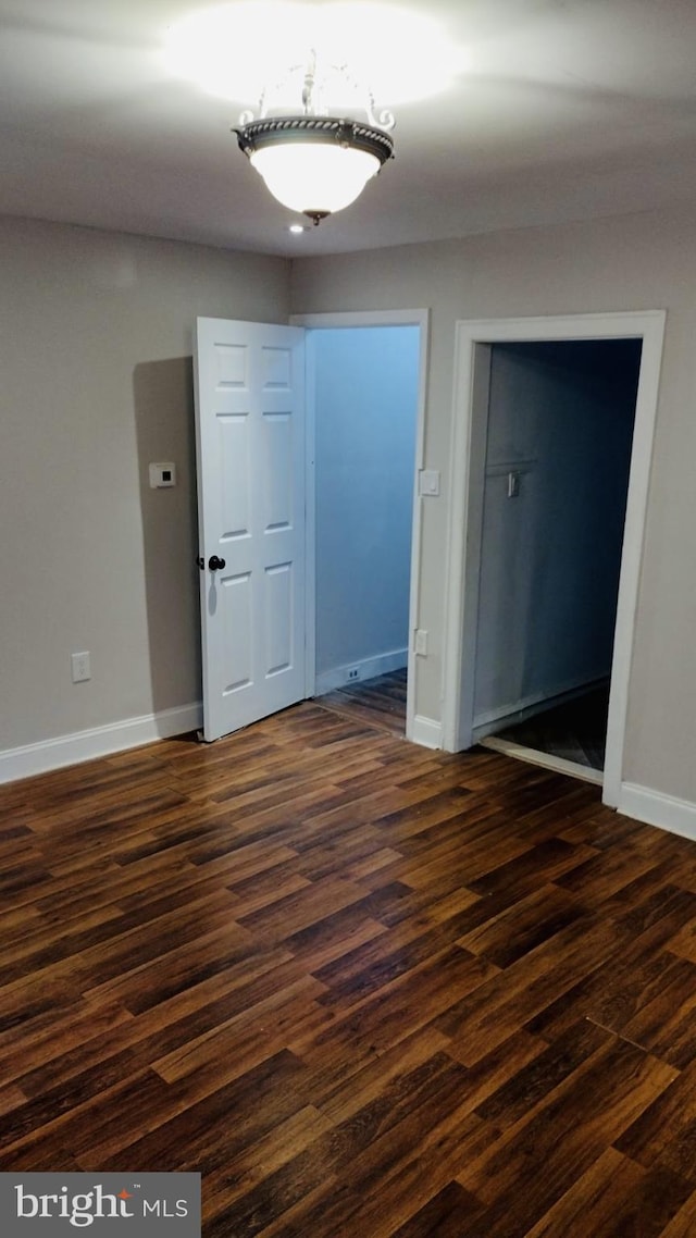 interior space with dark hardwood / wood-style floors and a closet