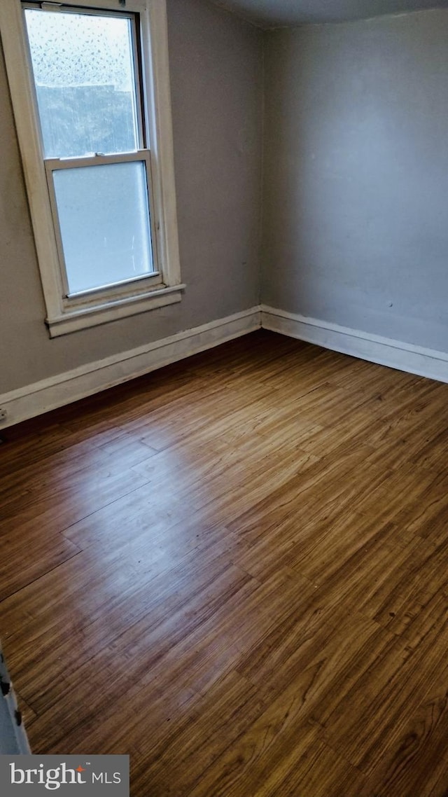 empty room featuring dark hardwood / wood-style flooring