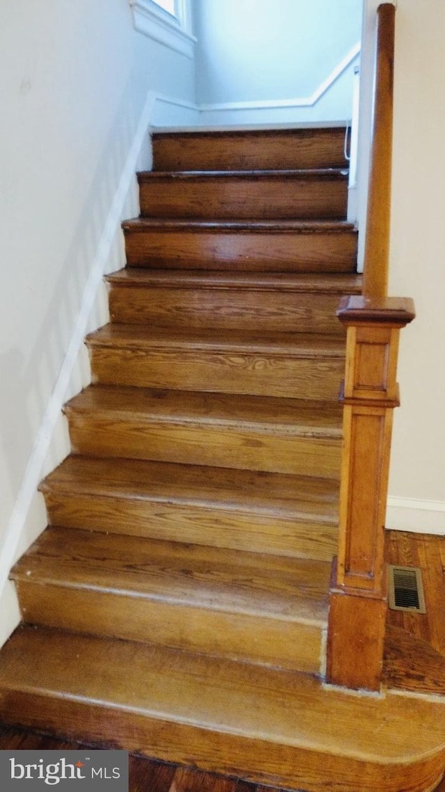 stairway featuring hardwood / wood-style floors