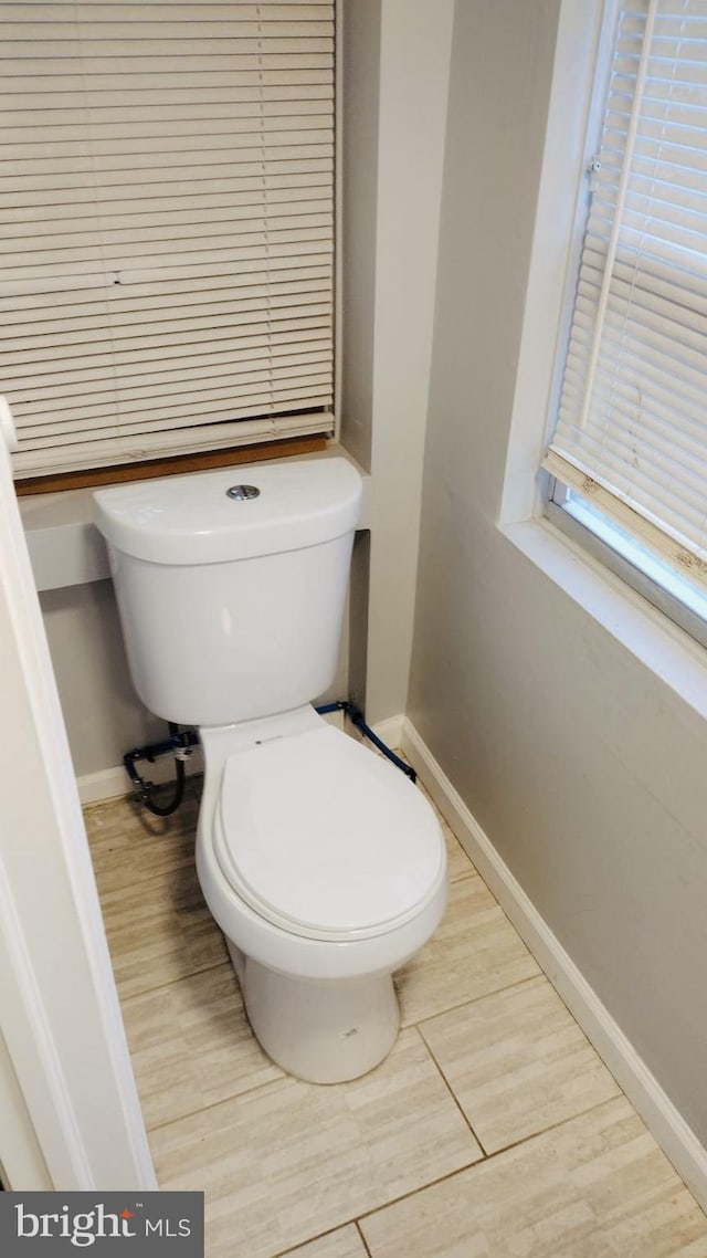 bathroom with wood-type flooring and toilet