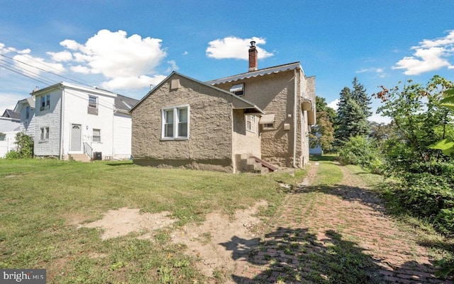 view of property exterior with a yard