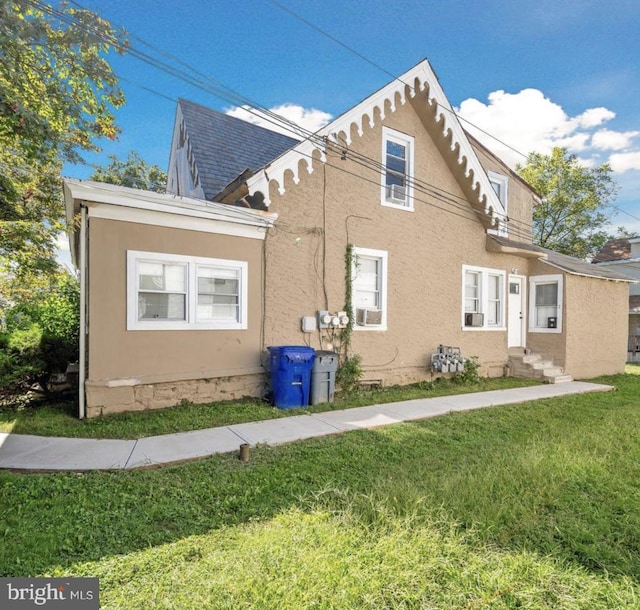 view of property exterior with a yard