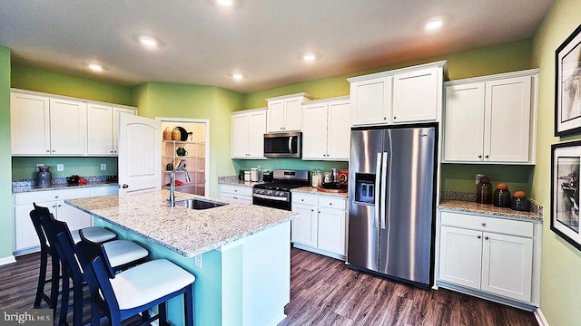 kitchen with appliances with stainless steel finishes and white cabinets