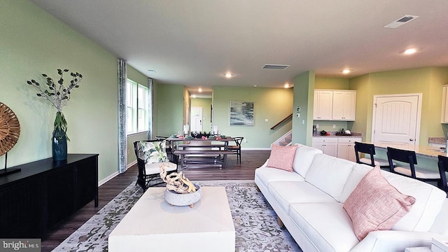 living room with dark hardwood / wood-style flooring