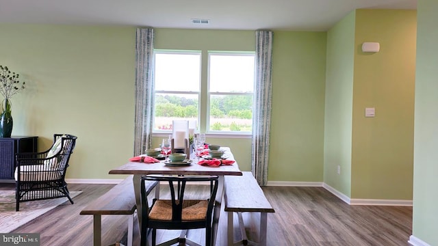 dining room featuring a healthy amount of sunlight and hardwood / wood-style flooring