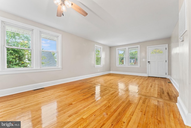 foyer entrance featuring ceiling fan, a healthy amount of sunlight, and light hardwood / wood-style flooring