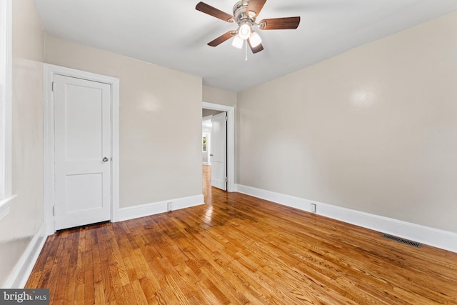 spare room with wood-type flooring and ceiling fan