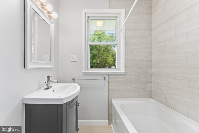 bathroom with vanity, tile patterned flooring, and a washtub