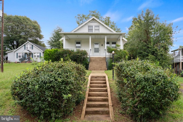 view of front of property with covered porch and a front lawn