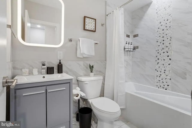 full bathroom with vanity, tile walls, shower / tub combo, and toilet