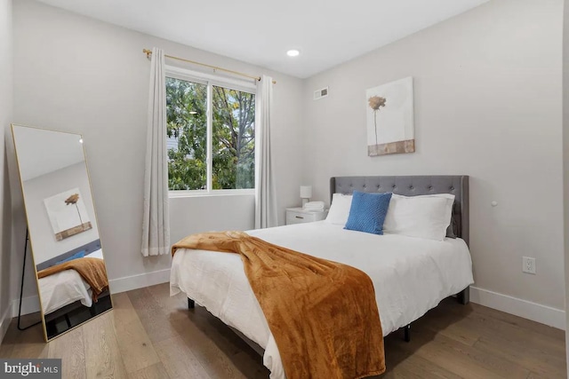 bedroom with hardwood / wood-style flooring