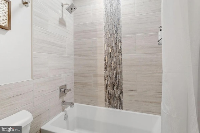 bathroom featuring toilet and shower / bathtub combination with curtain