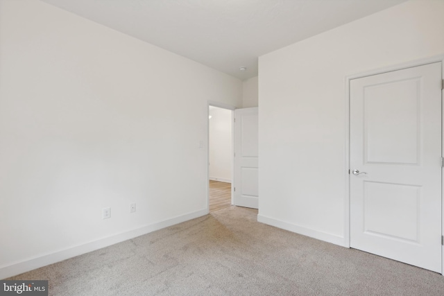 unfurnished bedroom featuring light colored carpet