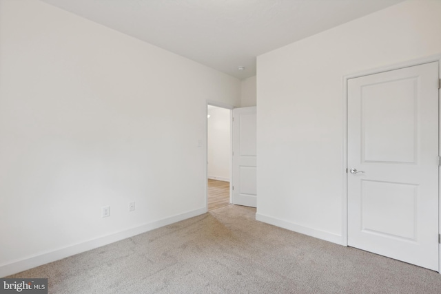 unfurnished bedroom featuring baseboards and carpet