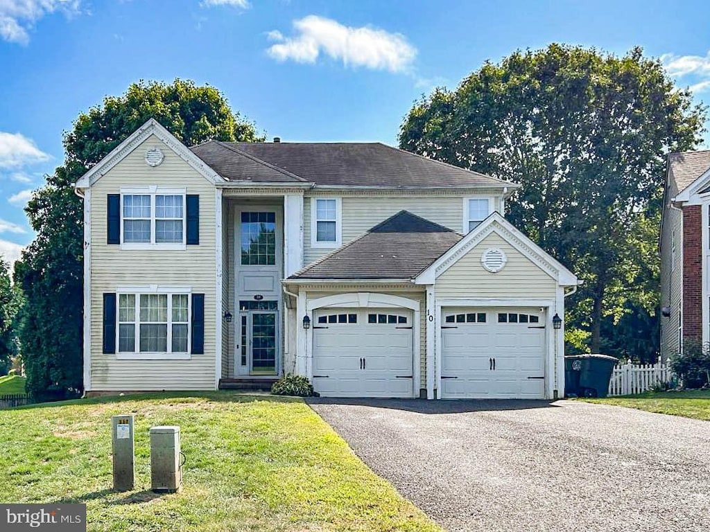 view of front property with a front yard and a garage