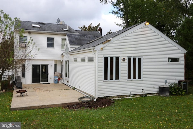 back of property featuring a patio area and a yard