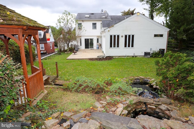 back of house with a lawn, a patio, and central AC unit