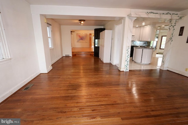 unfurnished living room with hardwood / wood-style flooring