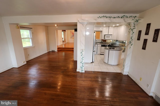 kitchen featuring white cabinets, white appliances, and light hardwood / wood-style floors