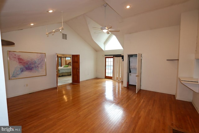 unfurnished living room with ceiling fan, hardwood / wood-style flooring, and high vaulted ceiling