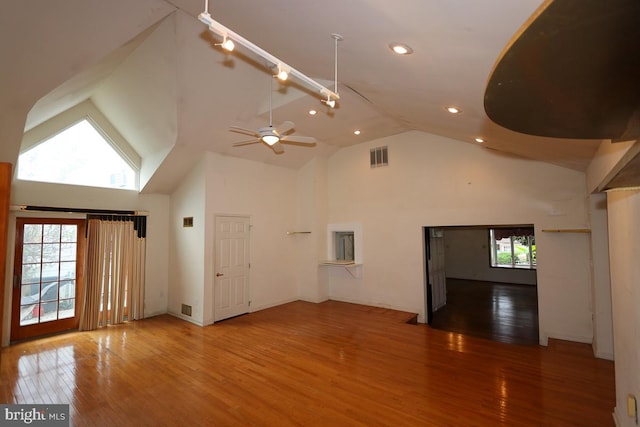 unfurnished living room featuring ceiling fan, hardwood / wood-style flooring, and high vaulted ceiling