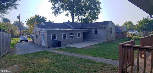 back of house featuring a patio and a yard