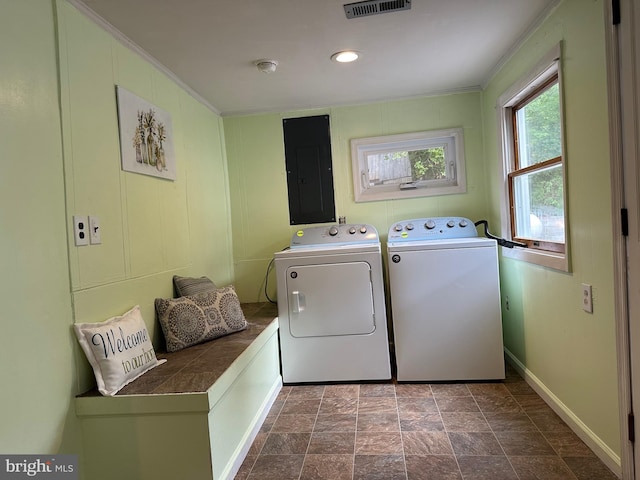 laundry room with electric panel and washer and clothes dryer