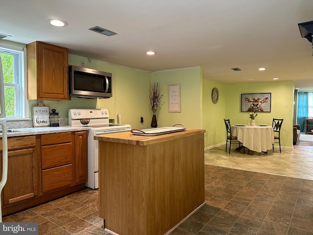 kitchen with a center island and white electric range