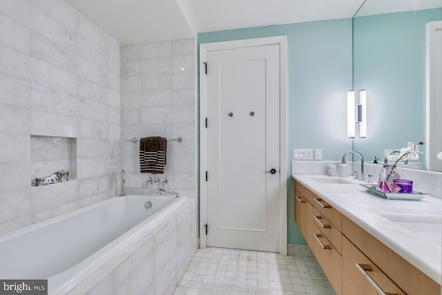 bathroom with vanity and a relaxing tiled tub