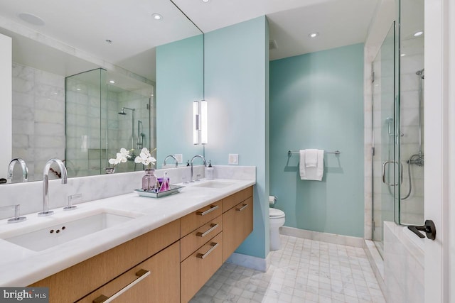 bathroom featuring toilet, an enclosed shower, and vanity