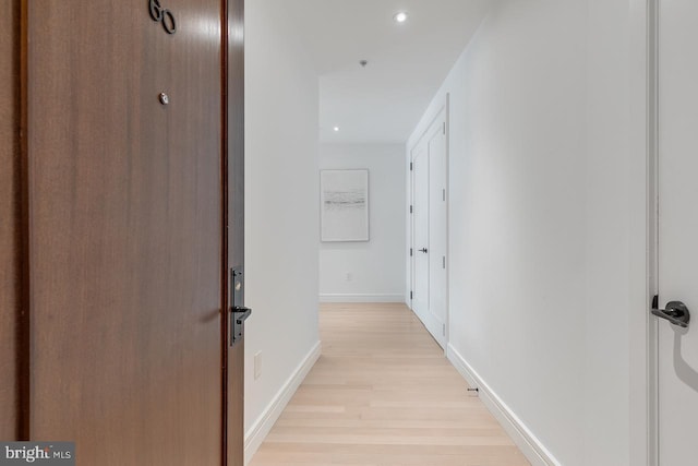 corridor with light hardwood / wood-style floors