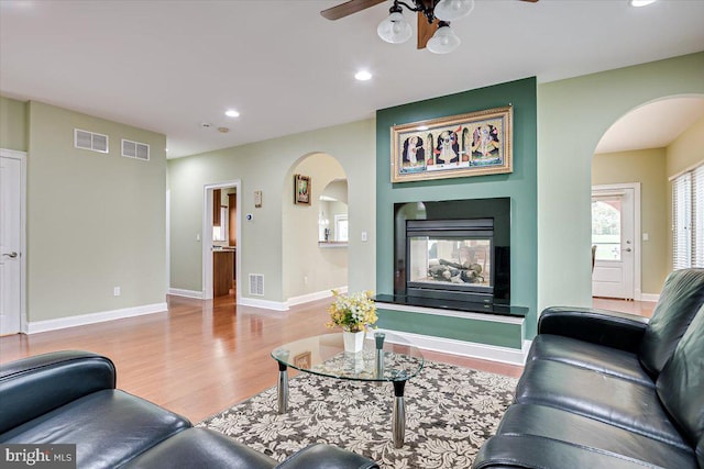 living room featuring light wood-type flooring and ceiling fan