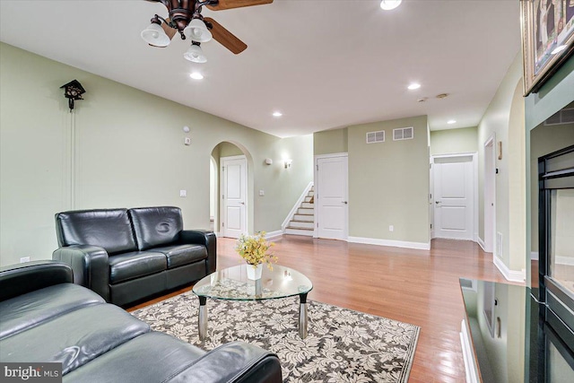 living room with ceiling fan and light hardwood / wood-style flooring