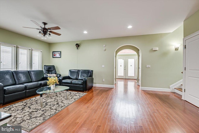 living room with ceiling fan, light wood-type flooring, and french doors