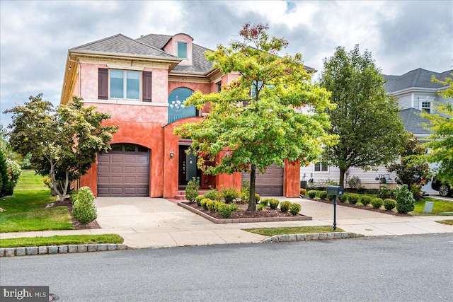 view of front of home featuring a front yard and a garage