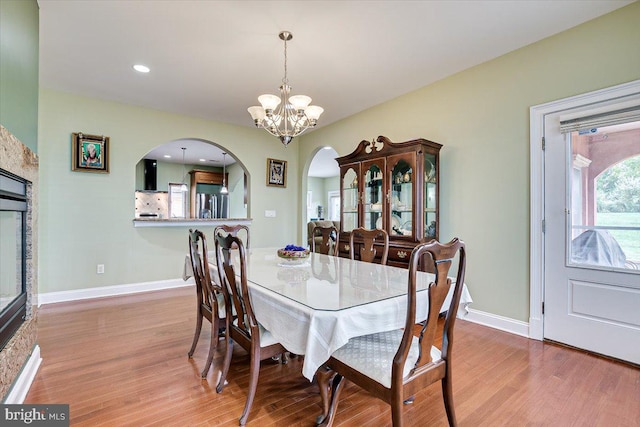 dining space with an inviting chandelier and light hardwood / wood-style floors