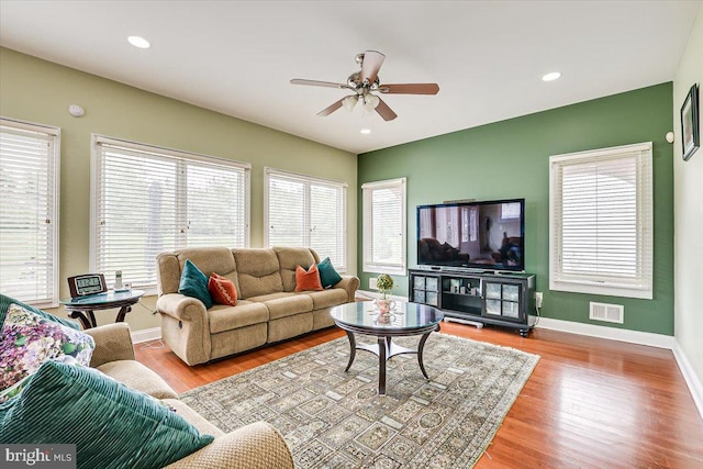 living room featuring ceiling fan and light hardwood / wood-style flooring