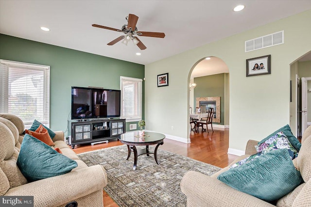 living room featuring ceiling fan and hardwood / wood-style floors