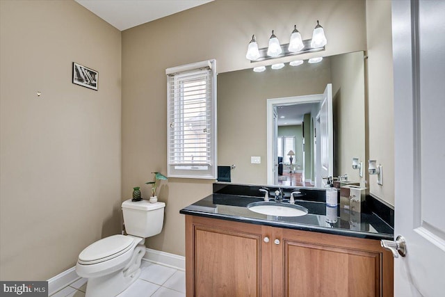 bathroom featuring vanity, tile patterned flooring, and toilet