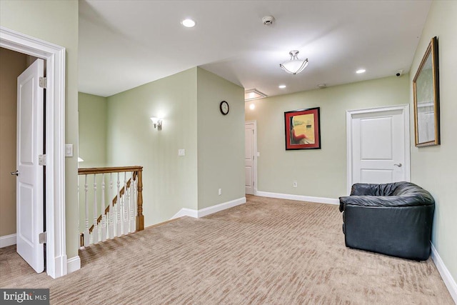 sitting room featuring light colored carpet