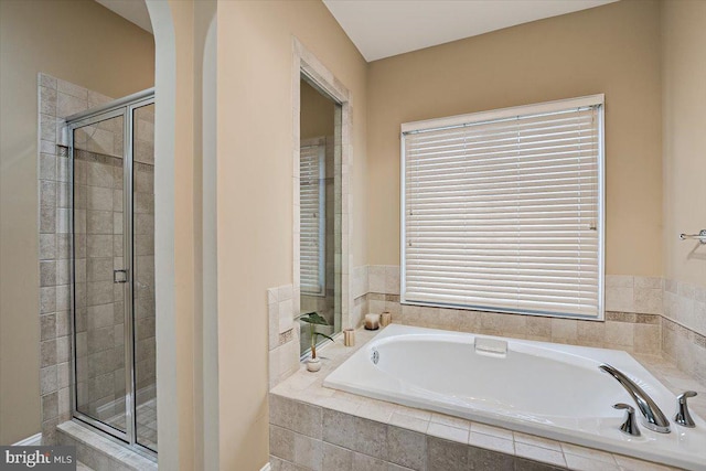 bathroom with shower with separate bathtub