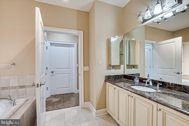 bathroom featuring vanity, tiled bath, and tile patterned floors