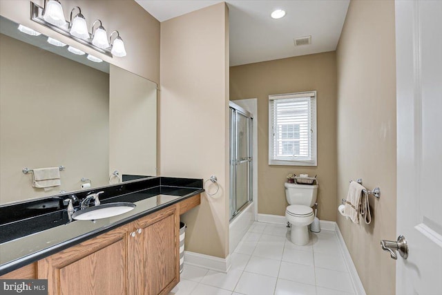 full bathroom with tile patterned flooring, shower / bath combination with glass door, vanity, and toilet