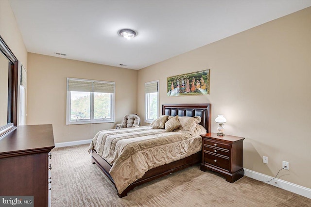 bedroom featuring light carpet