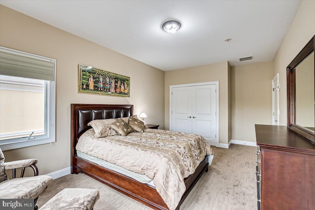 carpeted bedroom with a closet